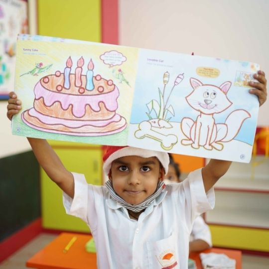 preprimary student drawing in a sketch book at vidyanchal school aundh pune
